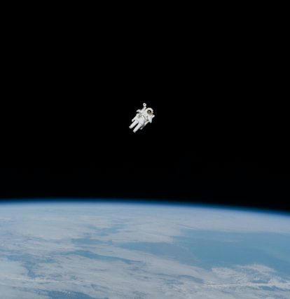 an astronaut floating in the air above the earth